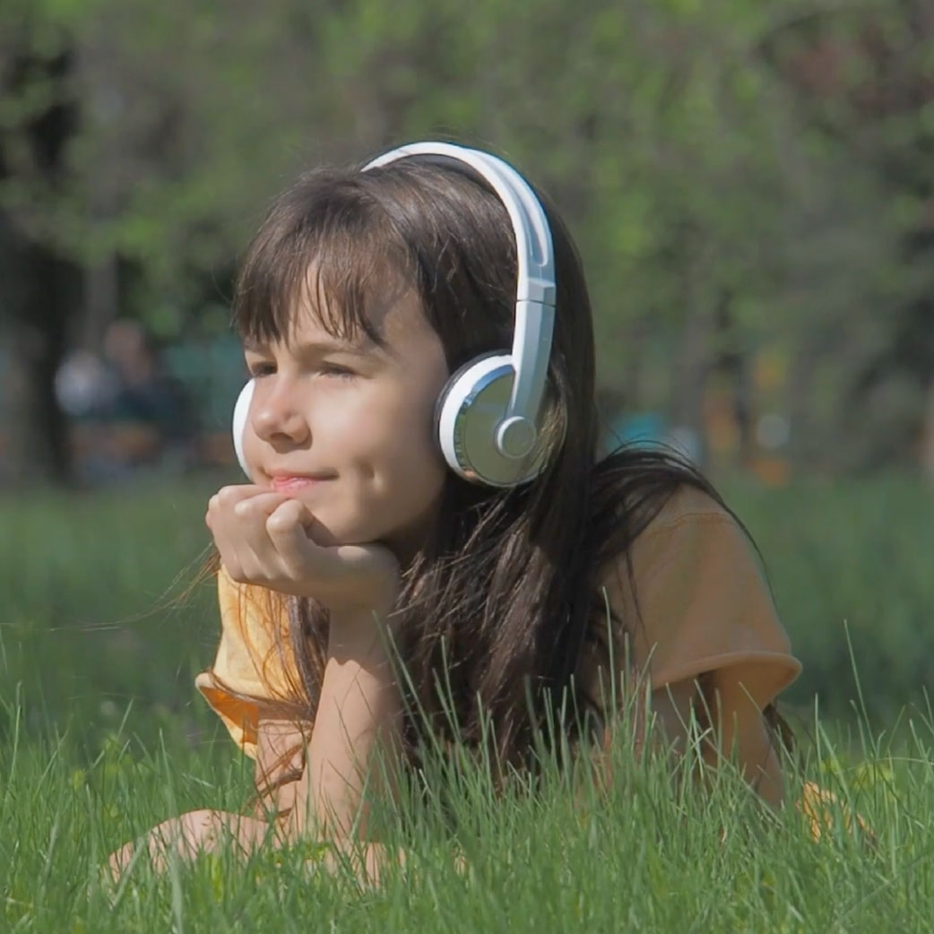 girl laying down wearing noise canceling headphones