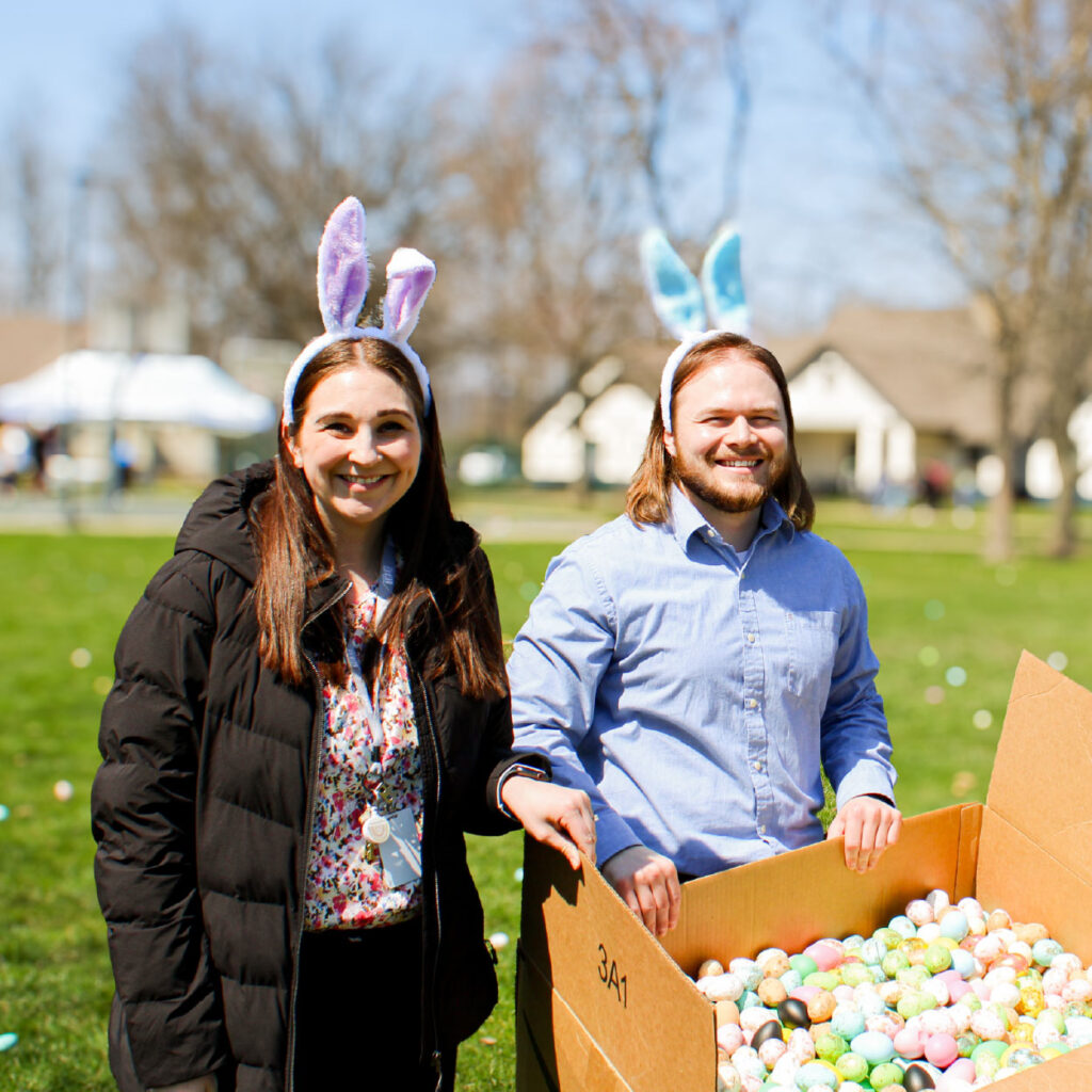 volunteers holding easter eggs and candy